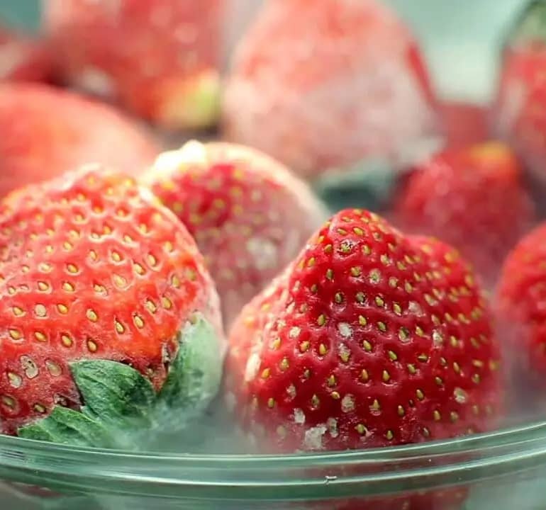 Frozen strawberries in a bowl.
